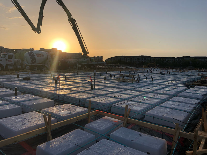 Wafflemat's concrete mat foundation system allows residential construction of multifamily buildings to continue progress despite rains that would disrupt a traditional foundation slab.